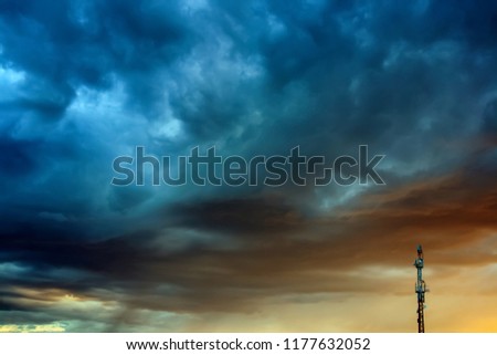 Telephone tower against stormy sky