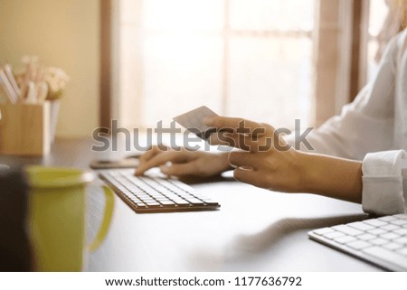 Closeup woman hands using computer for shopping online with vintage tone.
