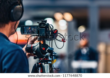 Cameraman recording at media press conference. Live streaming concept. Royalty-Free Stock Photo #1177648870