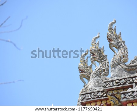 Naga statue with a sky background.