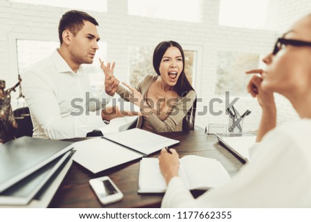 Upset Husband and Angry Wife in Office with Lawyer. Frustrated Husband. Problem in Relationship between People. Modern Law Office. Angry Young Wife. Marriage Problem. Young Advocate.