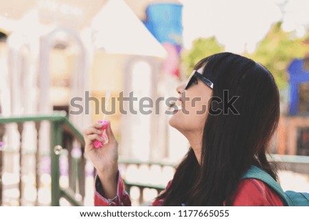 Travel Concepts. Beautiful girl is playing soap bubble fun. Asian girls are relaxing travels. Asian girls blowing bubbles into the air. Beautiful girl takes a break in playing bubble activities.
