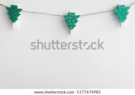 Christmas mockup with festive clothespins hanging on the clothesline on white background. Place for Christmas memories pictures. Winter holiday concept. Copy space.