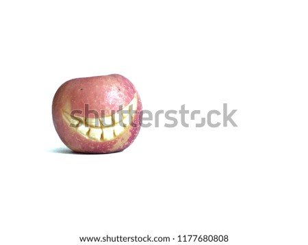 Red Apple with smiling face like the pumpkin for Halloween festival, on over white background. Decorative with carve fruits, with space for text. Halloween concept.