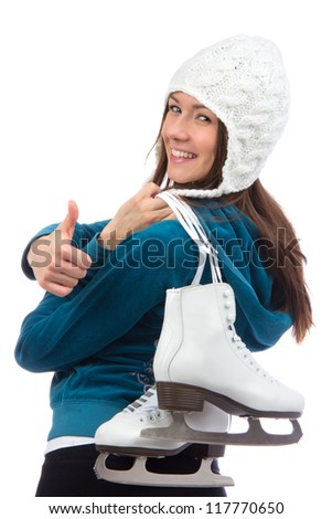 Young woman woman with  ice skates for winter ice skating sport activity in white hat smiling and thumb up isolated on a white background