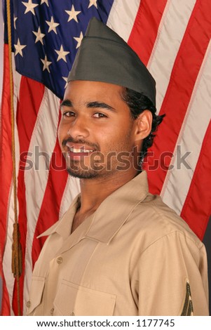 duty bound young man smiles nervously in front of American flag