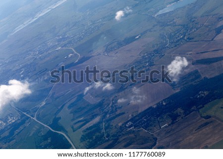 The beautiful green landscape of the Ukrainian city viewed from above is endless depth of clouds.