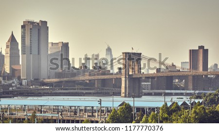 Retro stylized picture of the Brooklyn Bridge and Manhattan skyline, New York City, USA.