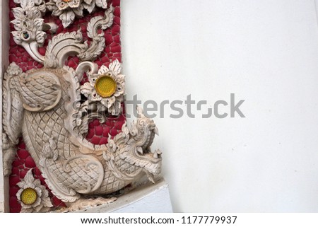 A beautiful clay sculpture decorated on the window at Wat Cheong Len depicting image of a mythological creature.