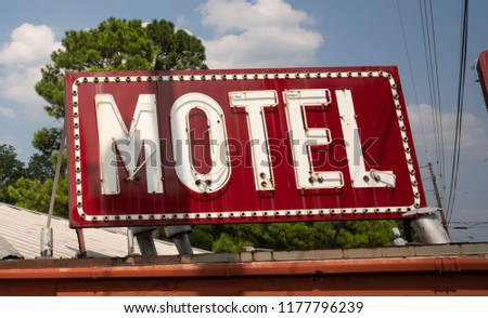 A vintage red motel sign on an old building in Texarcana, USA