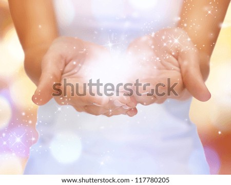 bright closeup picture of magic twinkles on female hands Royalty-Free Stock Photo #117780205