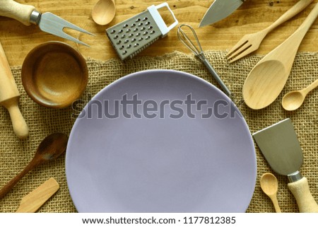 Top view,Empty purple dish and kitchenware for cooking with copy space and text