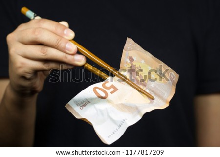 Woma holding chopsticks holding money
