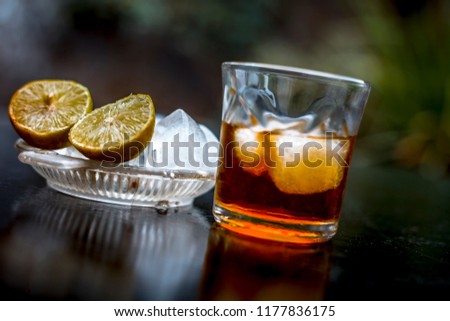Close up of hangover remedy i.e. lemon juice on wooden surface with Scotch or Scotch whiskey or Grain whiskey.
