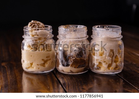 Dessert of sorbet and chocolate with caramel inside a glass jar.