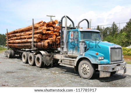 heavy loaded logging truck parking next to a coastal road on Vancouver Island, Canada