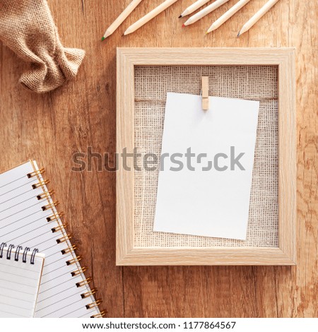 Autumnal mockup with wooden frame, crayons, notebook and a small jute sack