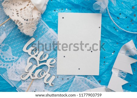 card mockup with white decor, ribbons, garlands, holiday for girl. craft envelope, flat lay, top view white lace. crown. Workspace. Wedding invitation card with copy space