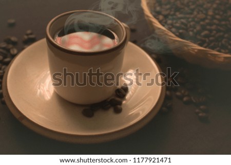 Roasted coffee cup and beans in basket with smoke