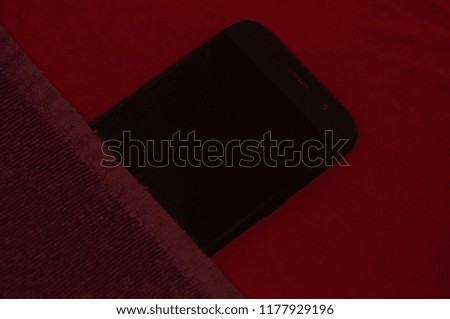 Mobile phone on the pillow and under the blanket