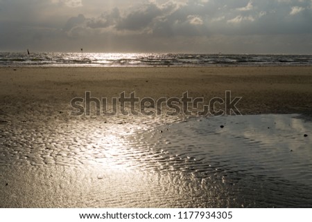 Sunset on the Beach of Norderney at low tide. Wide angle view