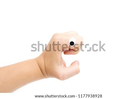 Female's hand with plastic eye on white background. Isolated on white