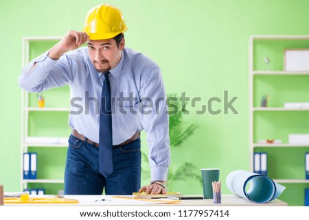 Young male architect working at the project