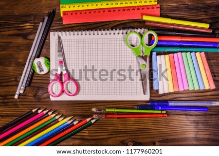 Different school stationeries on dark wooden table. Top view
