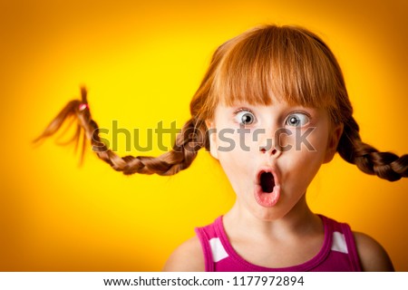 Silly, Surprised Little Girl with Pigtails Royalty-Free Stock Photo #1177972894
