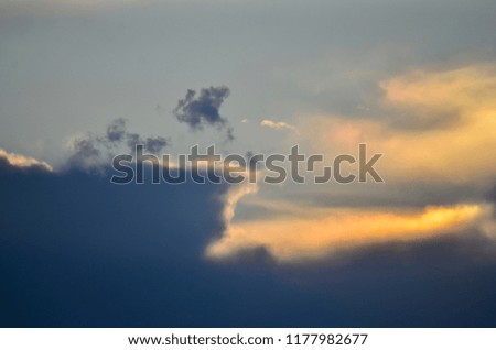 Golden Clouds Above Storm Clouds
