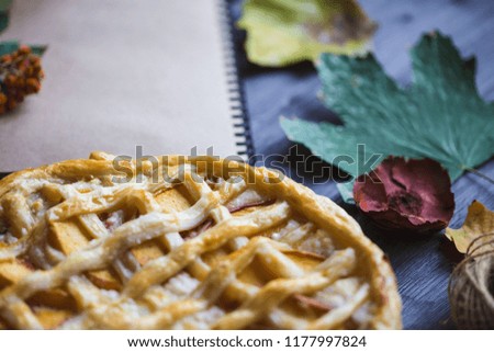 Autumn concept. Pie with Peaches Autumn Foliage Diary On a wooden background Copy space Top view