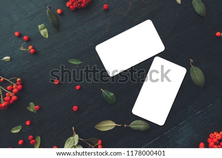 Flat lay business card with rounded corners mock up copy space top view on dark background decorated with wild berry fruit arrangement