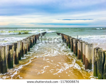 Ocean coast line with poles on a beach sea landscape photography