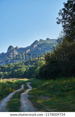 Picture of a dirt road in the mountains.