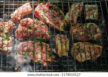 Picture of meat cooked on charcoal.