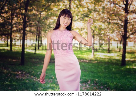 Portrait of beautiful  young asian girl with green eyes  in a park
