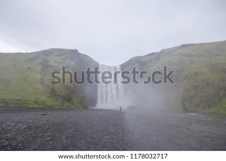 a waterfall in iceland between the mountains from the river spring