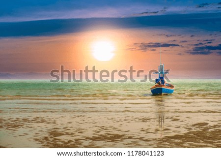 Fishing boat in the sea to catch fish out the morning sunset on a beautiful day. Pictures of imagination.hope and success concept.