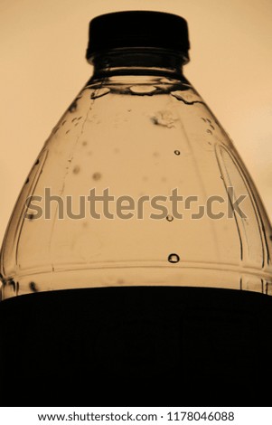 Silhouette of a plastic bottle of water. Dark picture.