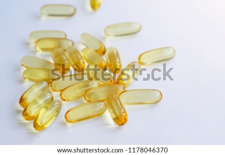 Selective focus of Fish oil capsules isolated on white background,vitamin D supplement,Take Omega 3 fish oil one a day,A food supplements for elderly people,Healthy lifestyle concept