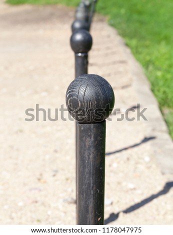 primitive metal stops for traffic with black wooden knobs