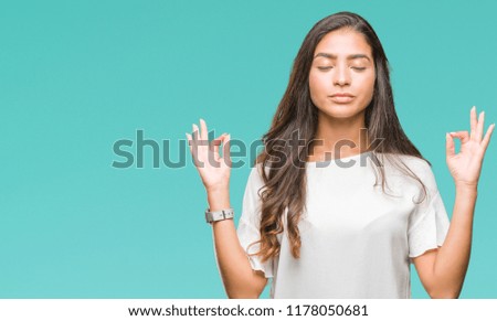 Young beautiful arab woman over isolated background relax and smiling with eyes closed doing meditation gesture with fingers. Yoga concept.