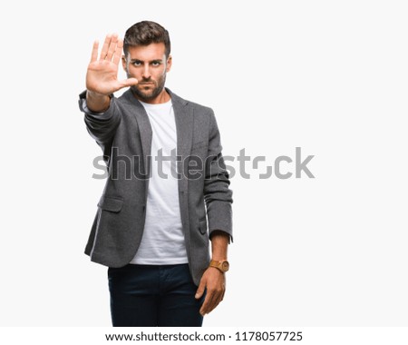Young handsome business man over isolated background doing stop sing with palm of the hand. Warning expression with negative and serious gesture on the face.