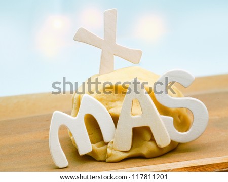 Seasonal background with freshly prepared dough left to rise on a kitchen countertop decorated with the letters XMAS for preparing Christmas cookies for family and friends