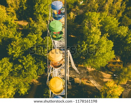 aerial top directly above view of ferris wheel in summer amusement public city park, drone shot