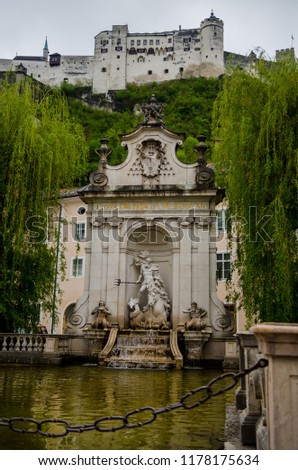 Vertical picture of famous fountain and castle in Salzburg