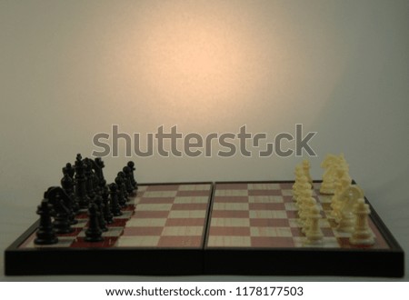 Chess, pieces are placed on the board. Smart game for two develops strategic thinking. A close-up shot on a white background.
