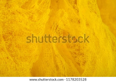 Texture background, pattern. Mesh yellow fabric. Ideal for accents on your design, wallpapers and home decor. Colors include white and yellow.