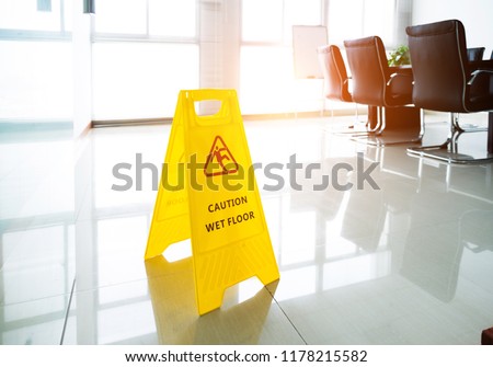 Wet floor caution sign in office.