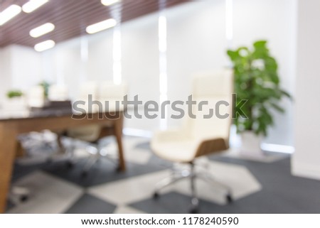 Modern meeting room with large windows, soft focus